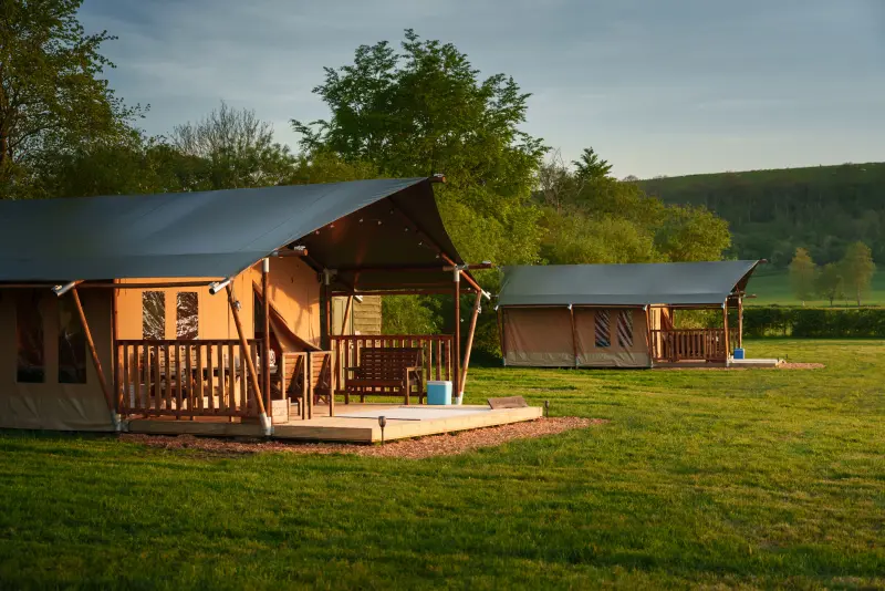 Two safari tents in daylight at Chalke Valley Camping