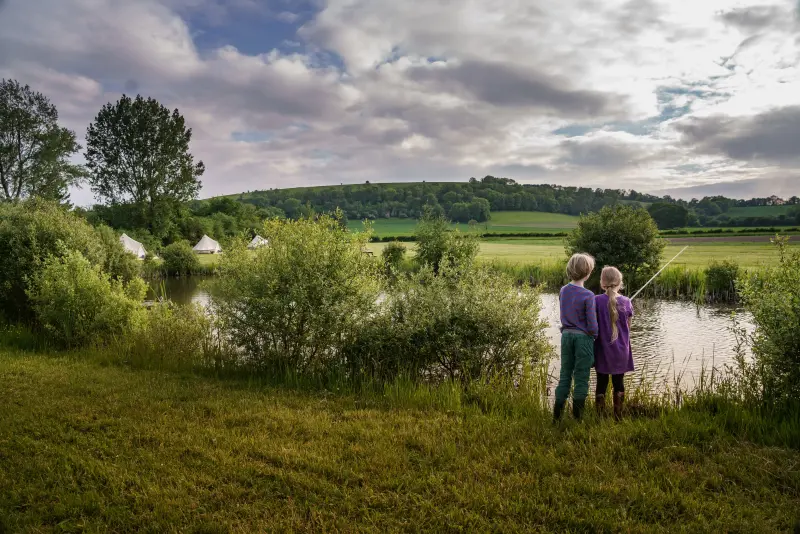 Girl and boy fishing at the pond at Chalke Valley Camping